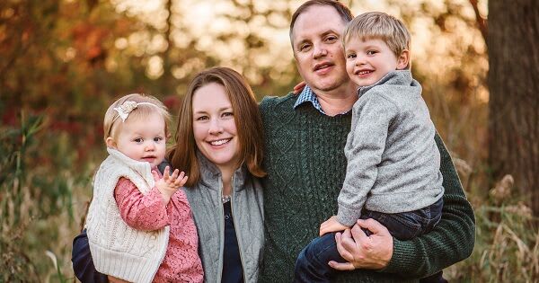 Jennifer Endicott and her husband holding their two children