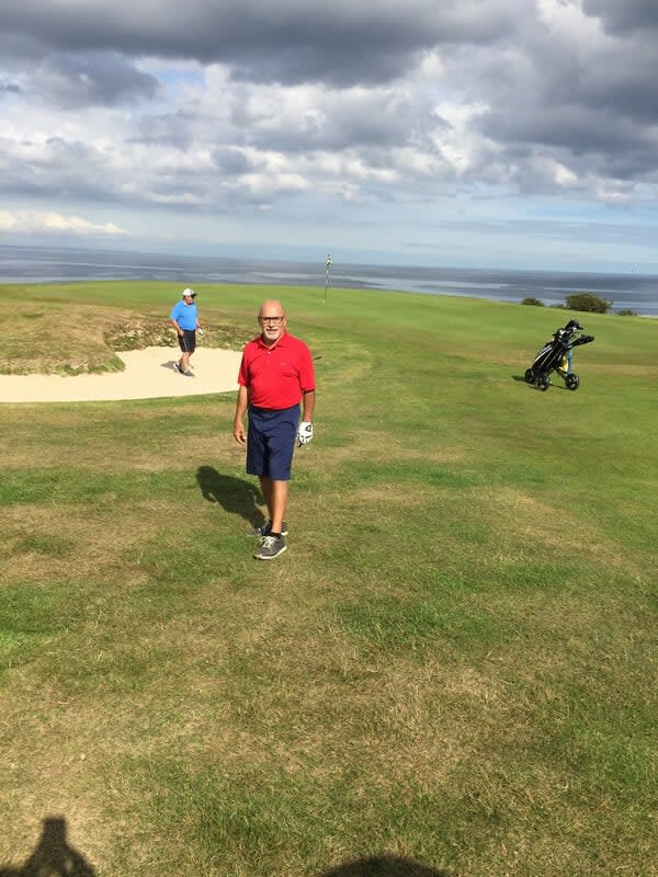 John DeSimone walking on a golf course