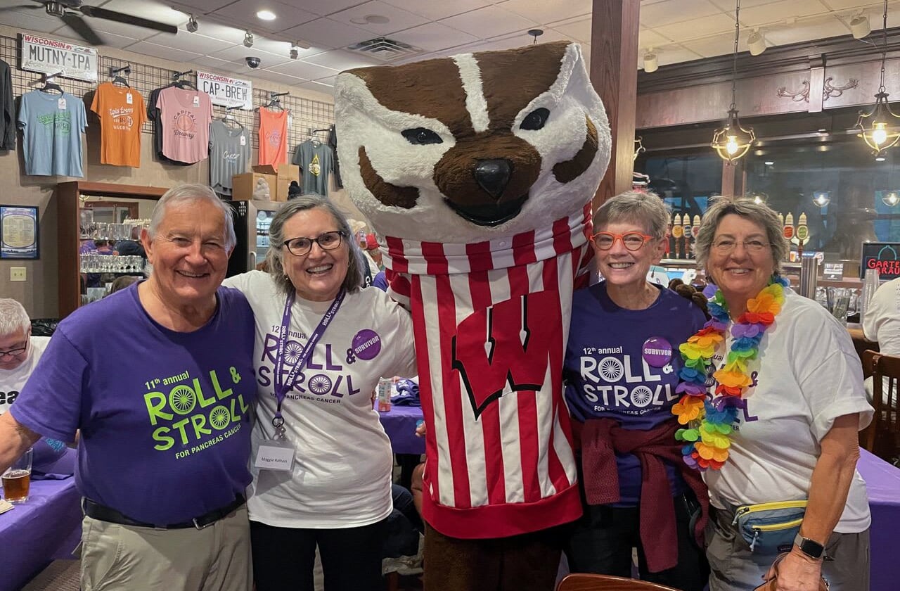 Charli Fulton with loved ones for a group photo with mascot.