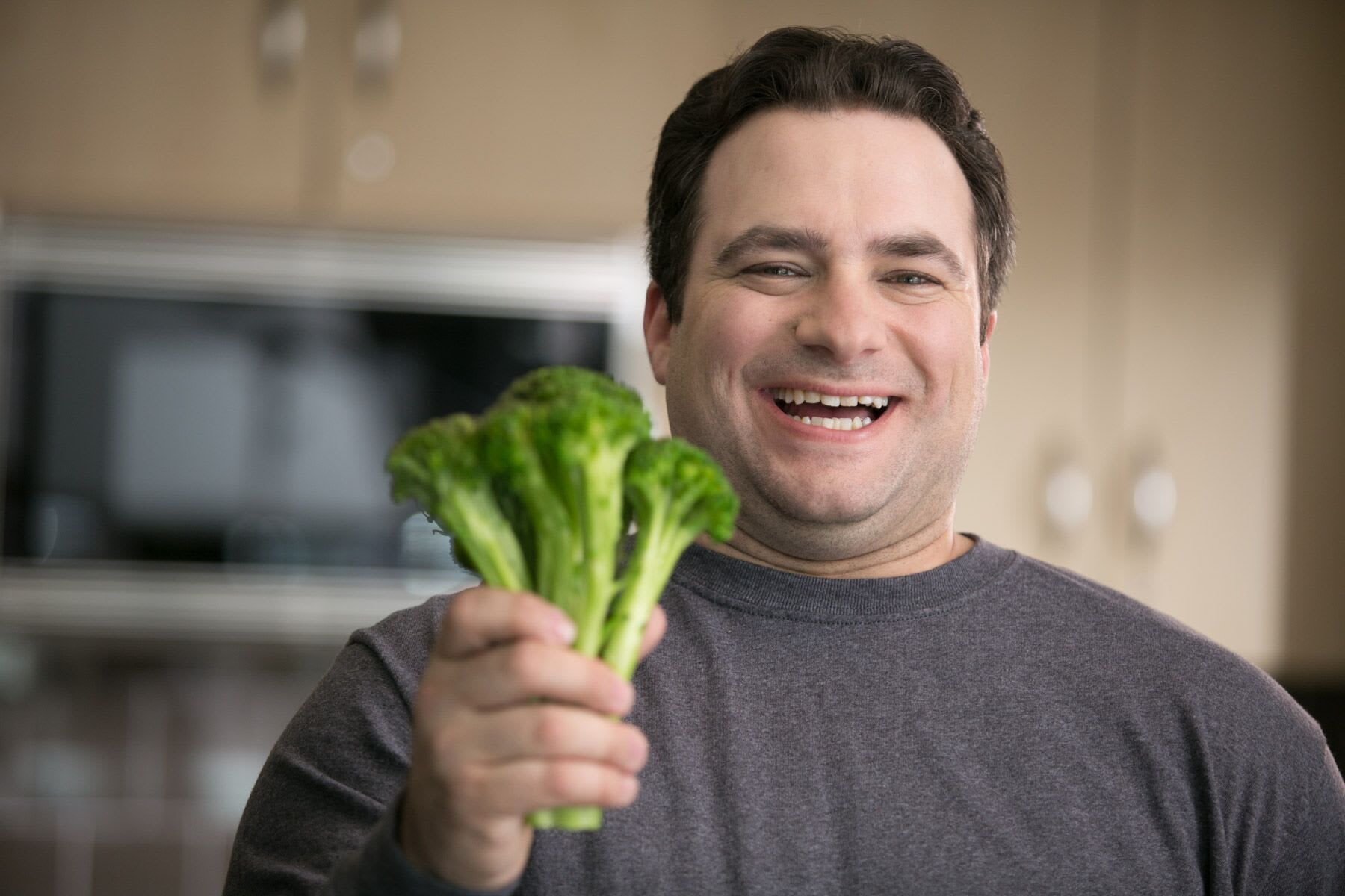 Cardiac rehabilitation patient Joe Servick holding broccoli