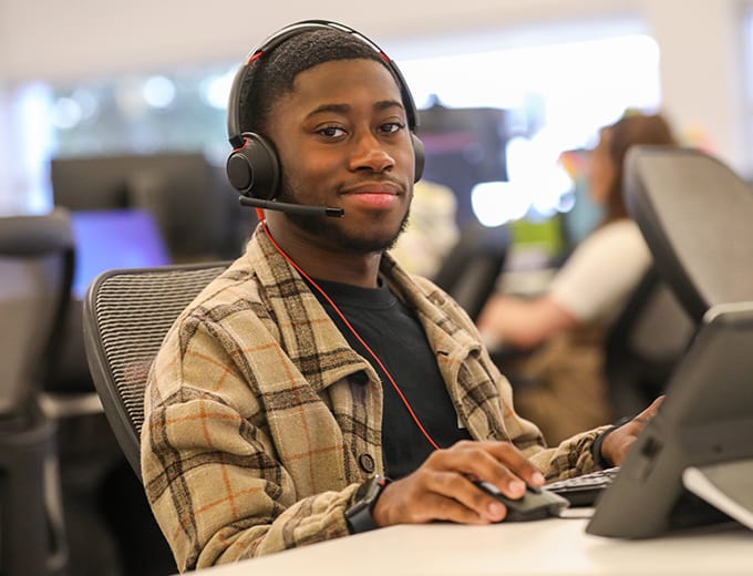 A Mortgage Operations team member smiling at a desk
