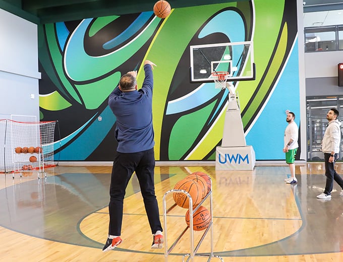 A team member shooting hoops in the on-site gym