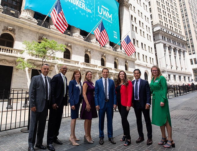 The UWM executive leadership standing in front of the New York Stock Exchange