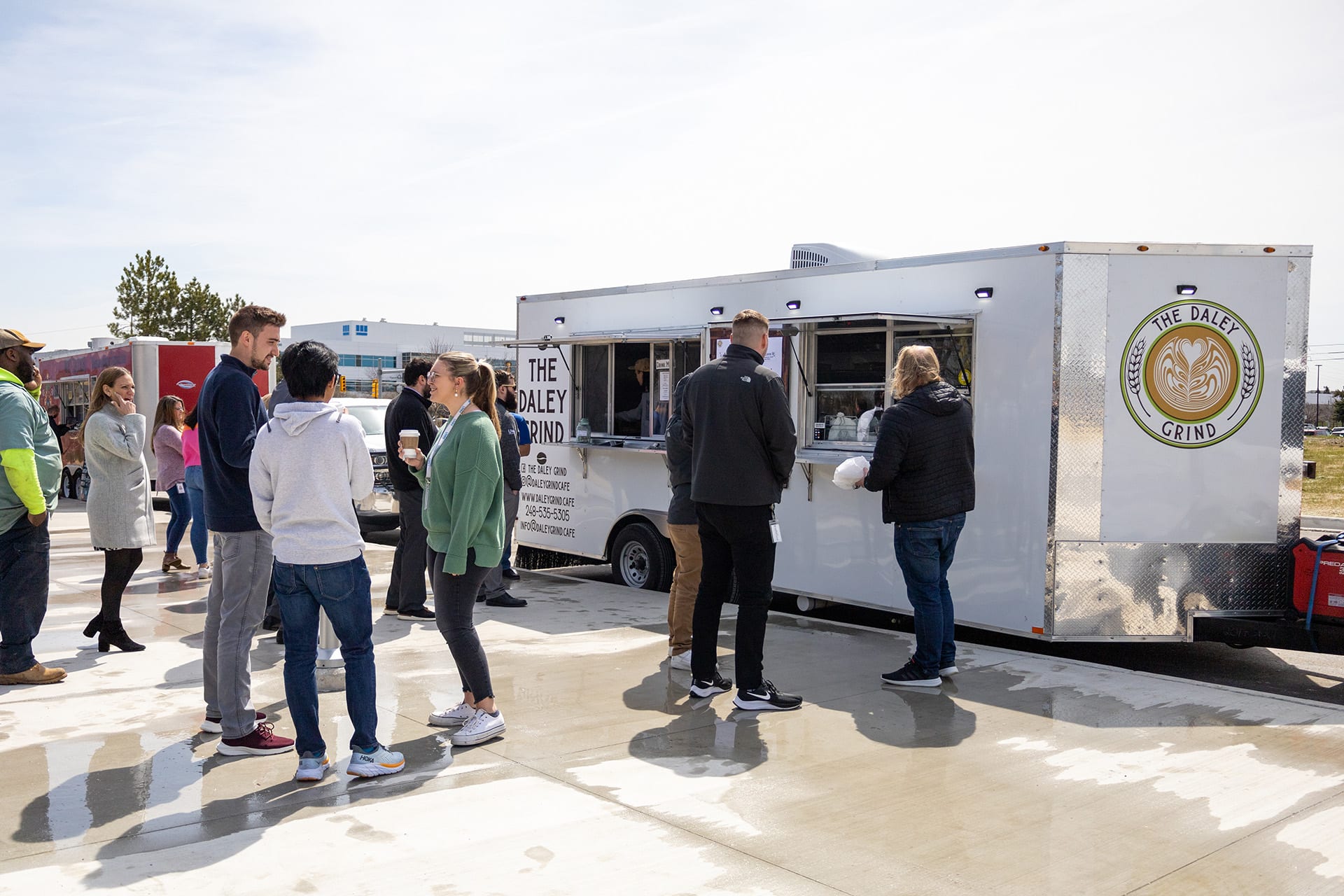 Team members gathered outside an on-site food truck