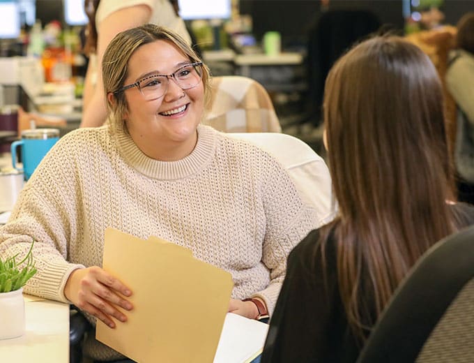 A Human Resources team member helping another UWM team member