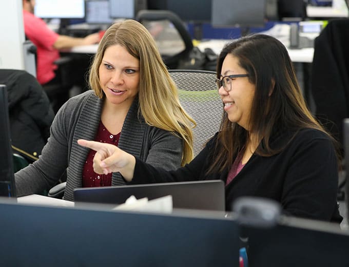 Loan Servicing team members working together at a desk
