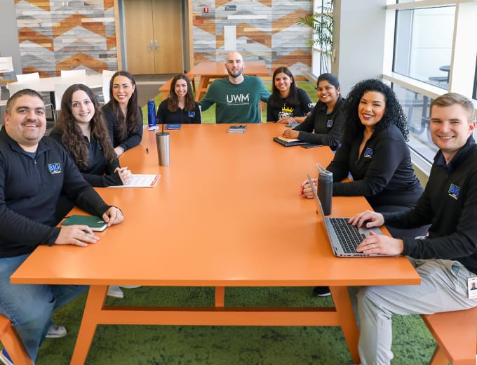 Several Special Programs team members at a desk in a conference room