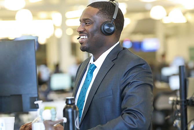 A smiling Account Executive at their desk