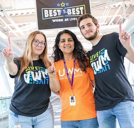 UWM team member Veterans holding one finger out to signify being the best of the best work force