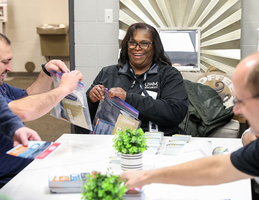 A happy team member volunteering at a local charity