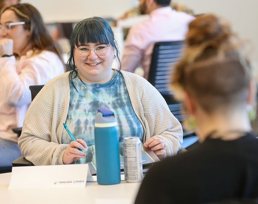 A UWM team member sitting at a desk going through the Business Analyst Experience class