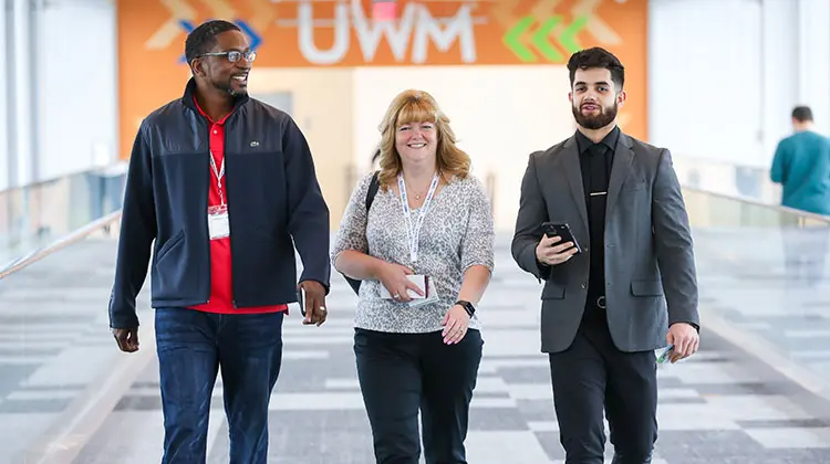 Broker partners and an account executive walking to the South building on the campus to attend a broker Success Track training course.