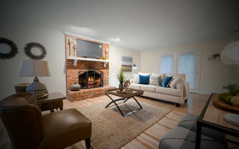 A bright, freshly cleaned living room with a brick fireplace