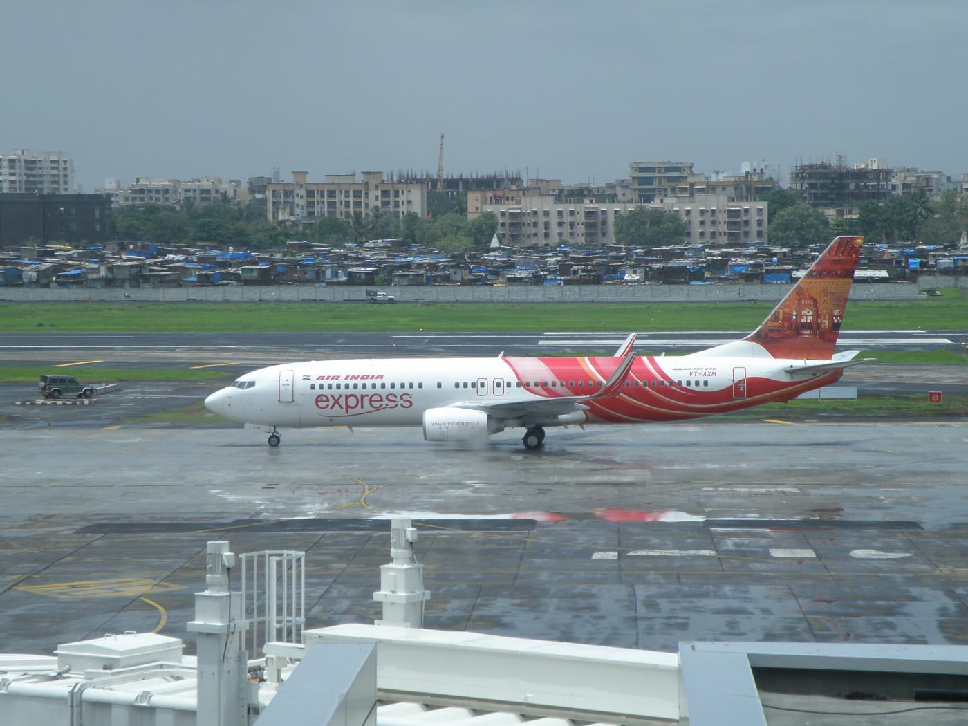 Air India Express aircraft VT-AXM in front of domestic departure terminal 1C at Chhatrapati Shivaji International Airport