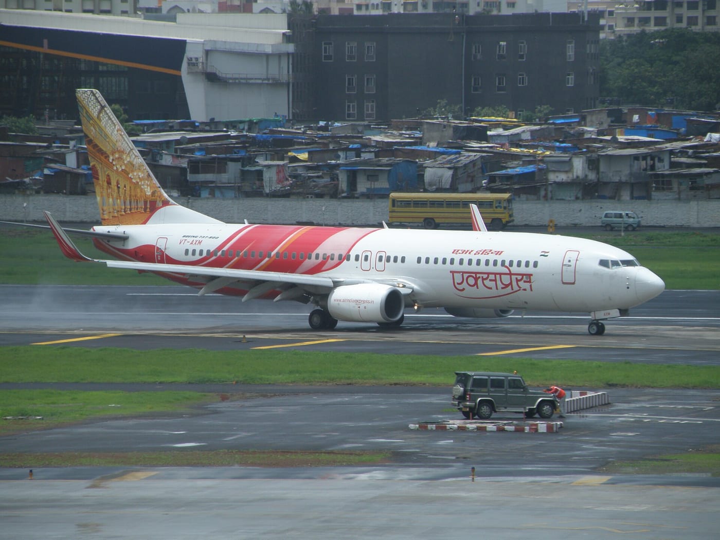 Air India Express aircraft VT-AXM in front of domestic departure terminal 1C at Chhatrapati Shivaji International Airport
