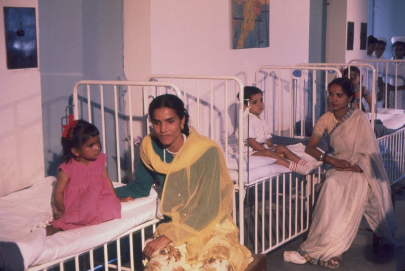Several women and children sit in the children’s ward of the All-India Institute of Medical Sciences in New Delhi, India, during First Lady 