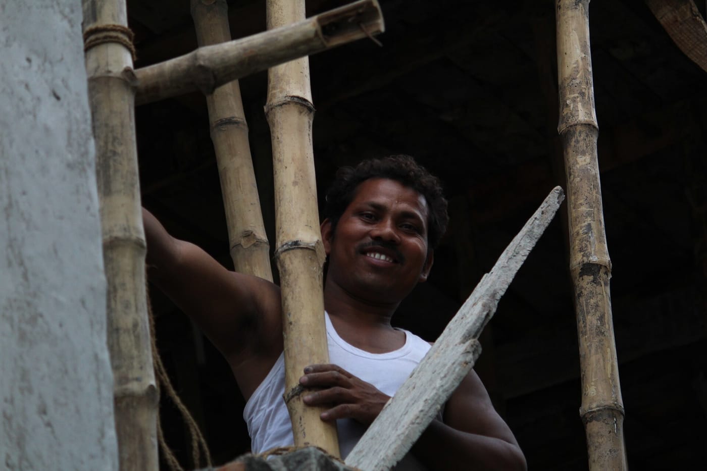 An Indian Male labour working at a building construction area.