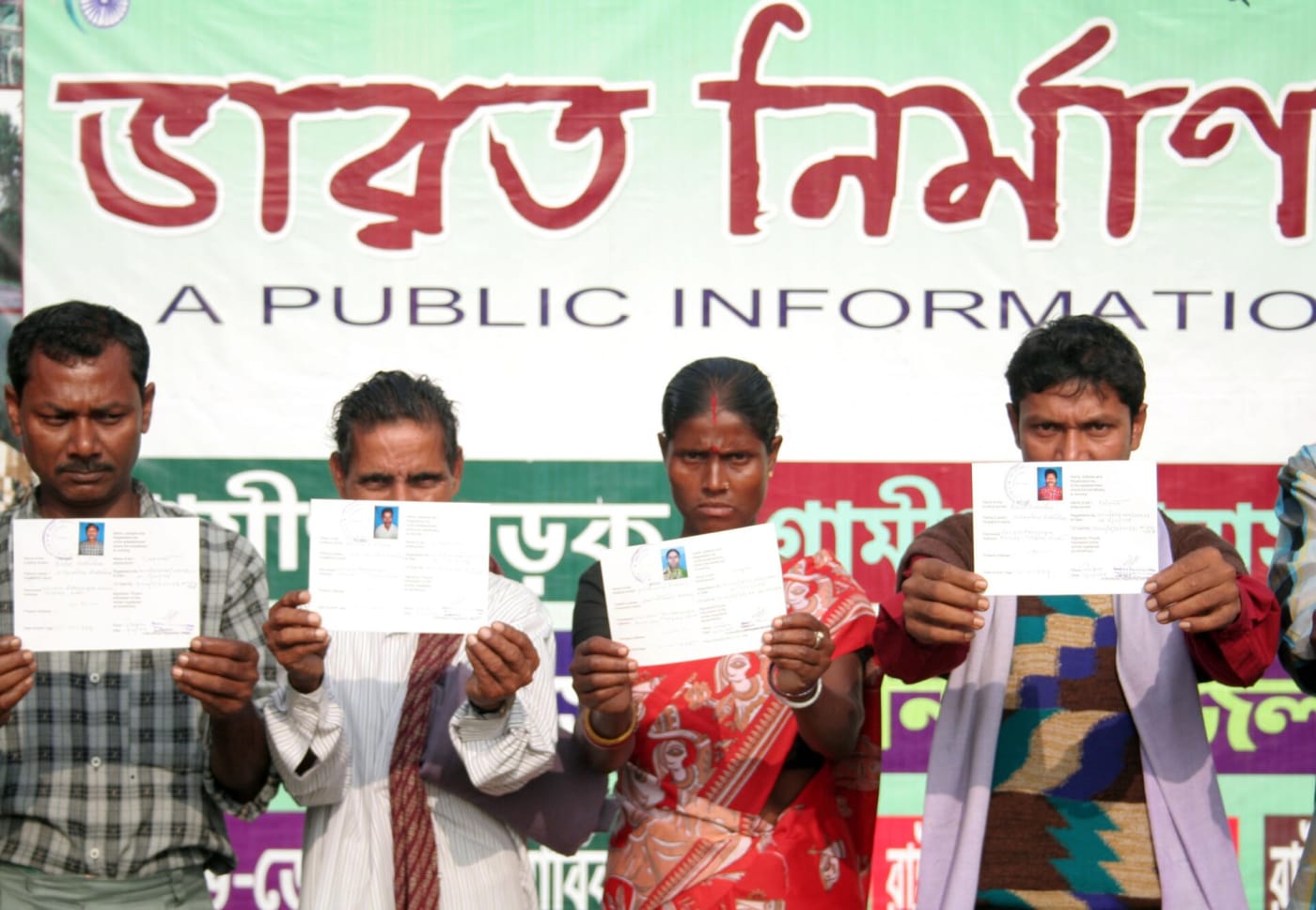 The unorganised construction workers holding identity cards presented at the Public Information Campaign on Bharat Nirman, in Belonia, Tripu
