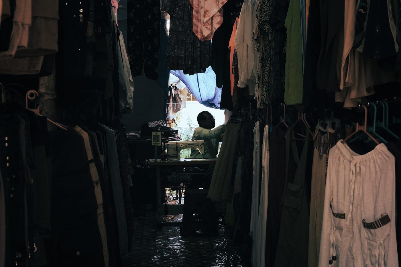 A worker can be seen engaged in sewing.