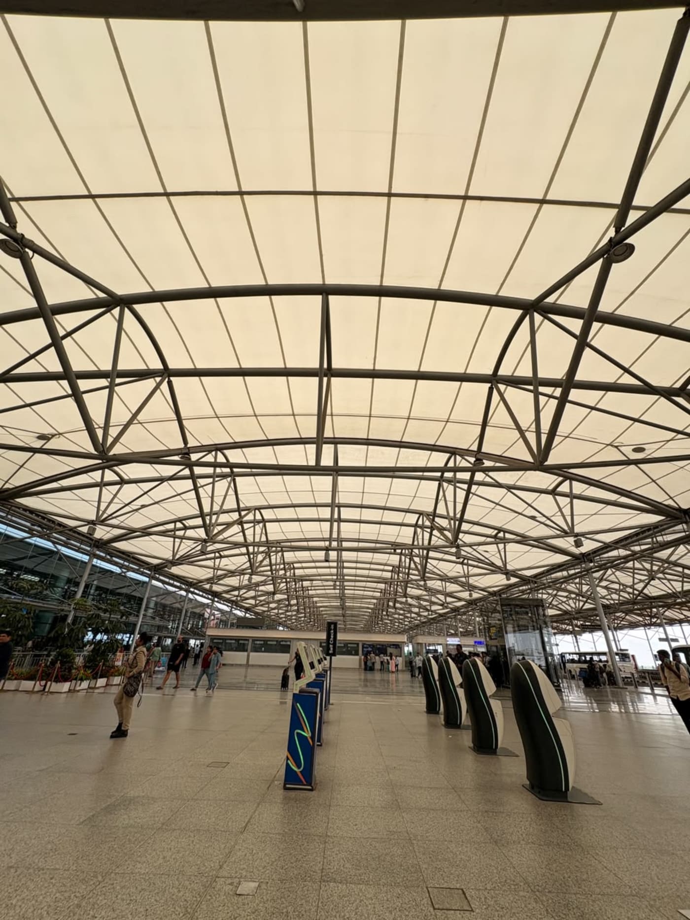 Interior view of the departure terminal at Rajiv Gandhi International Airport (HYD) in Hyderabad, India. The photograph showcases the airpor