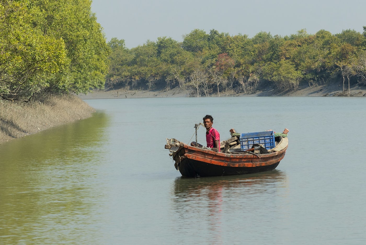 Fisherman on a boat in Sundarbans National Park, West Bengal, India