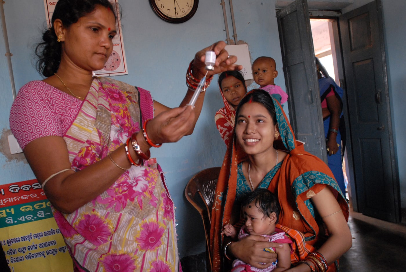 A community health worker gives polio drops to a baby in Odisha.