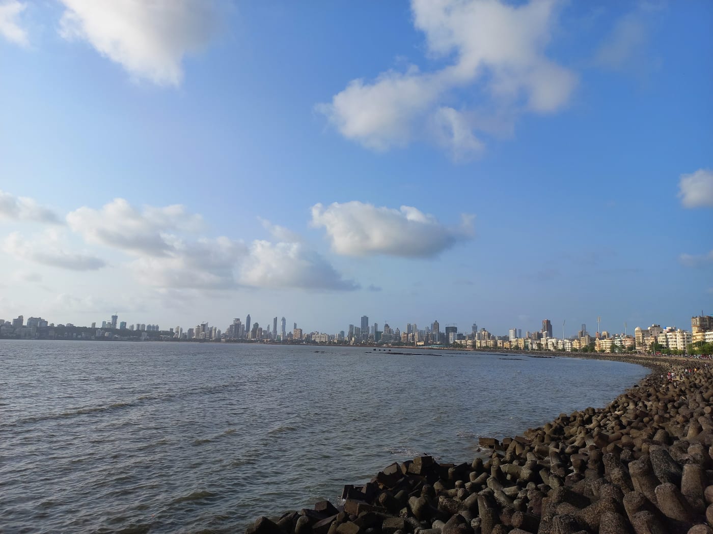Blue sky over the Arabian Sea and the city skyline seen from Marine Drive, Mumbai, Maharashtra.