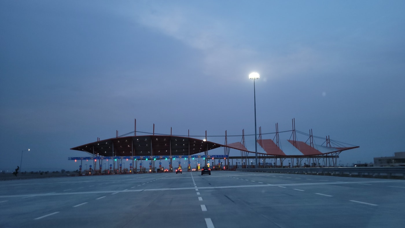 Hilalpur Toll Plaza on the Delhi–Mumbai Expressway at dusk.