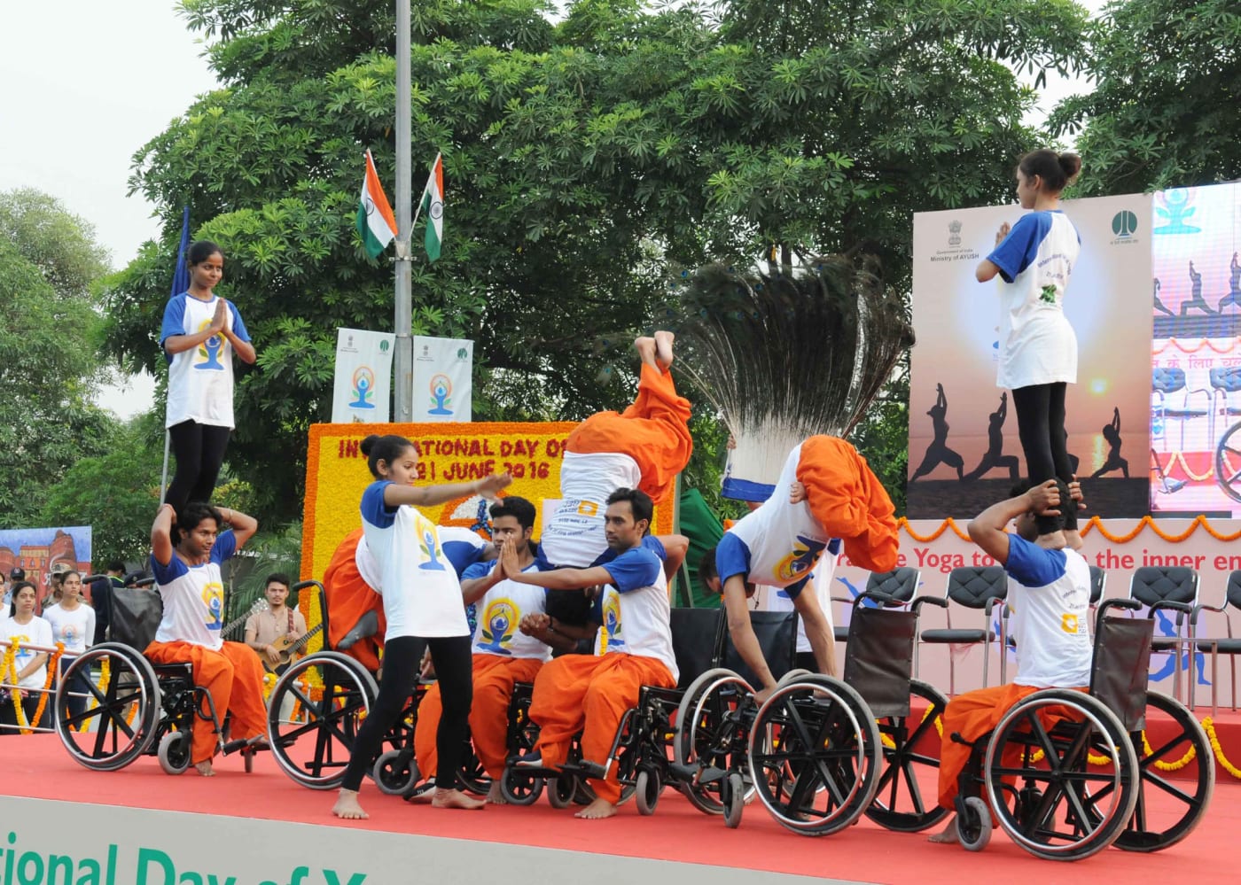 Young wheelchair users perform yoga on International Day of Yoga at Connaught Place, New Delhi.
