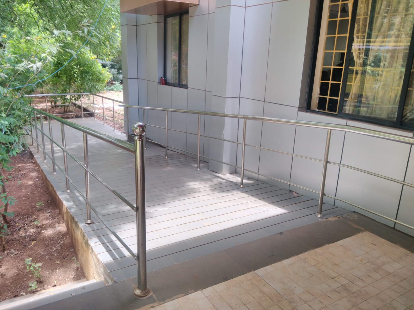 A wheelchair ramp with steel handrails at Bharathidasan University, Tiruchirappalli, Tamil Nadu.
