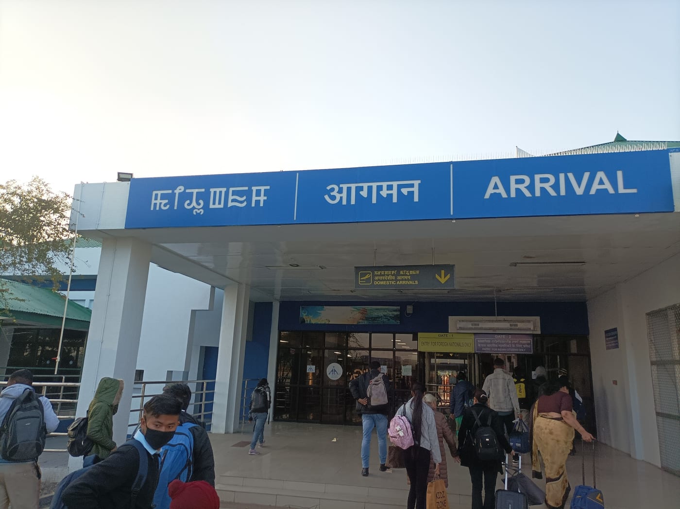 A trilingual arrival sign in Meitei, Hindi and English at Imphal International Airport, Manipur.