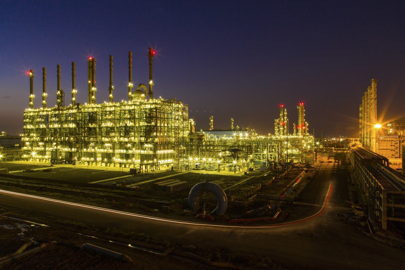 The OPaL petrochemical complex at Dahej, Gujarat, lit up at dusk.