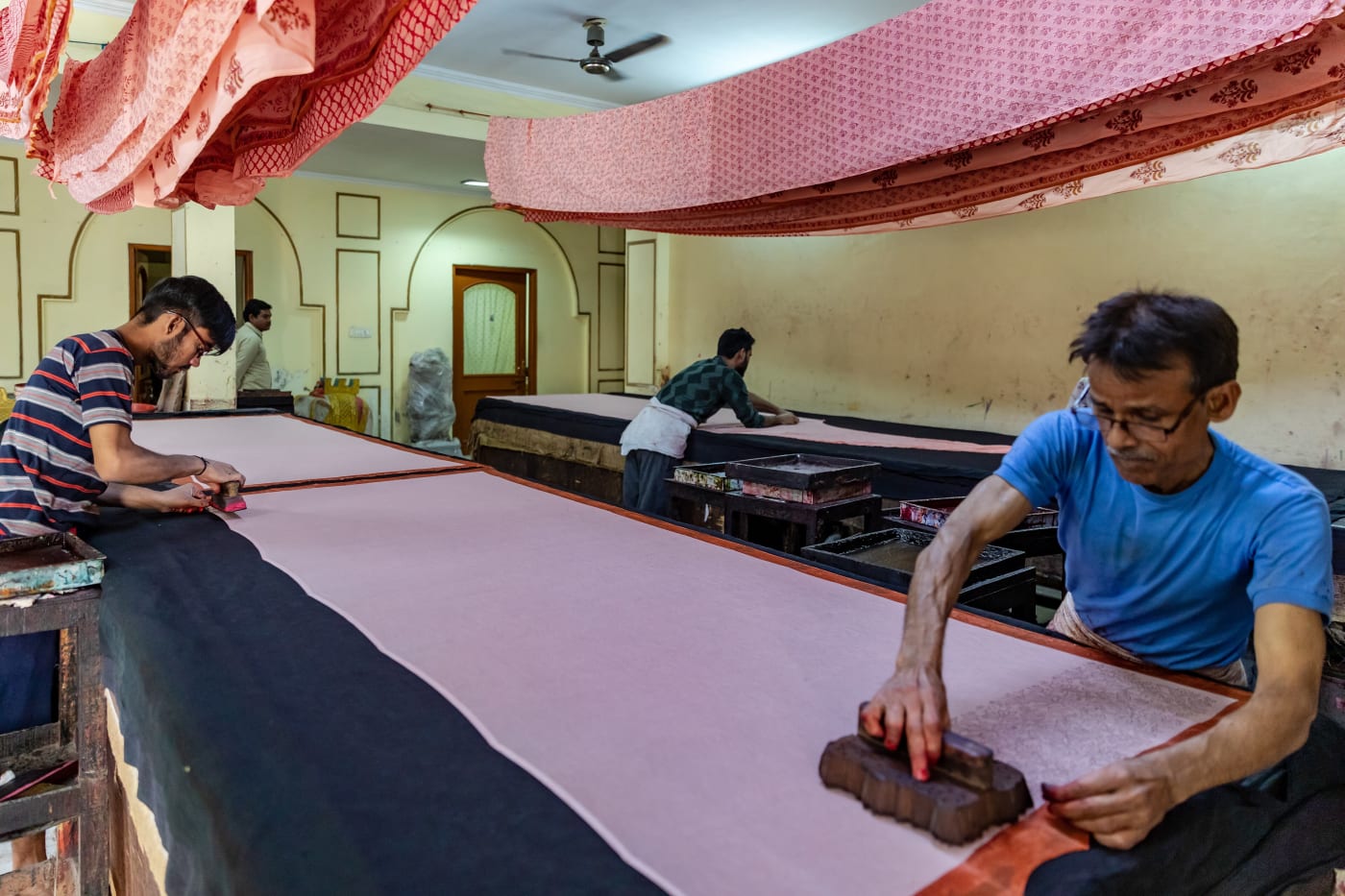 Workers block-printing fabric at a textile factory in Jaipur, Rajasthan.