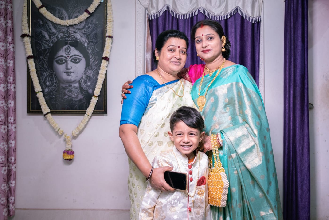 A family in traditional attire at a celebration in Kharagpur, West Bengal.