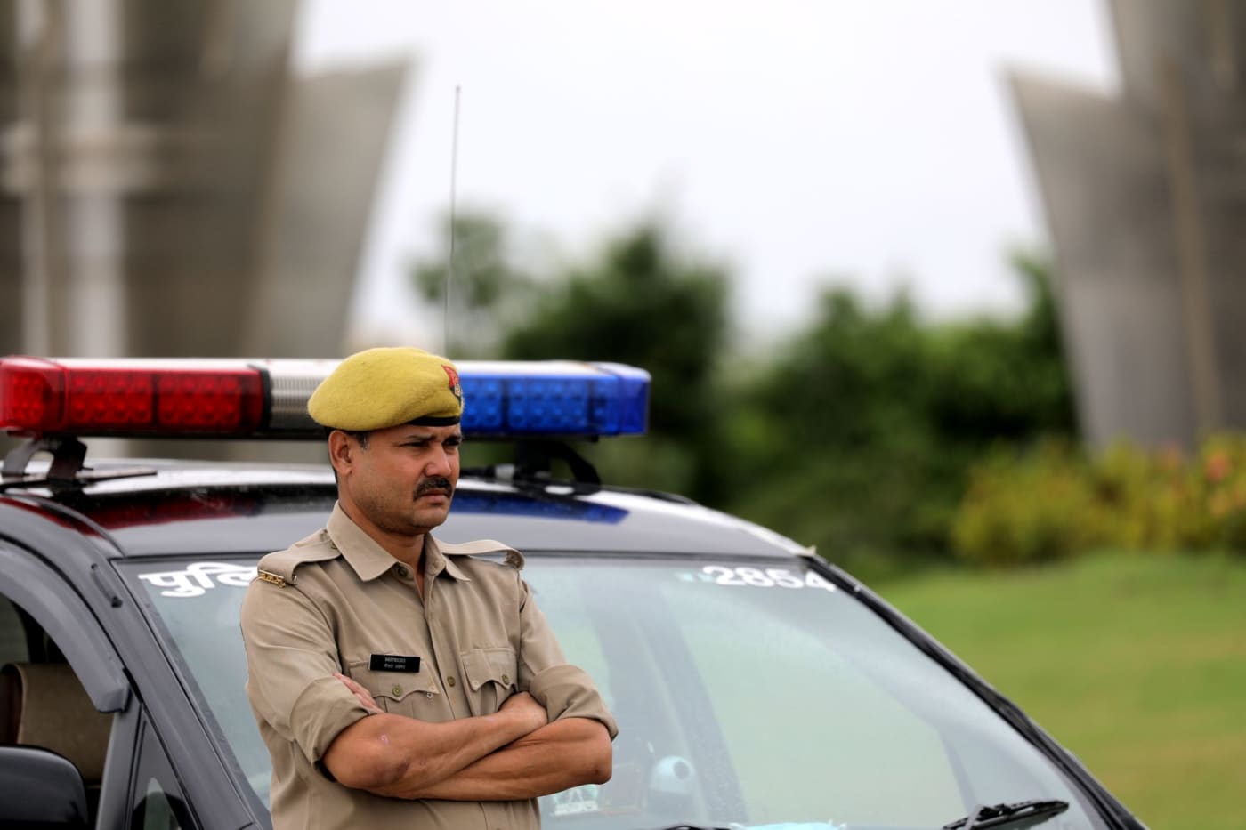 A police officer beside a patrol car in Uttar Pradesh.
