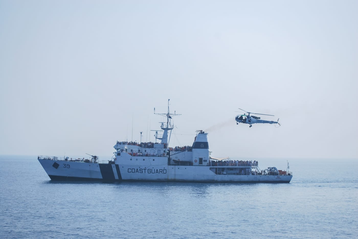 An Indian Coast Guard ship and helicopter at sea off Visakhapatnam.