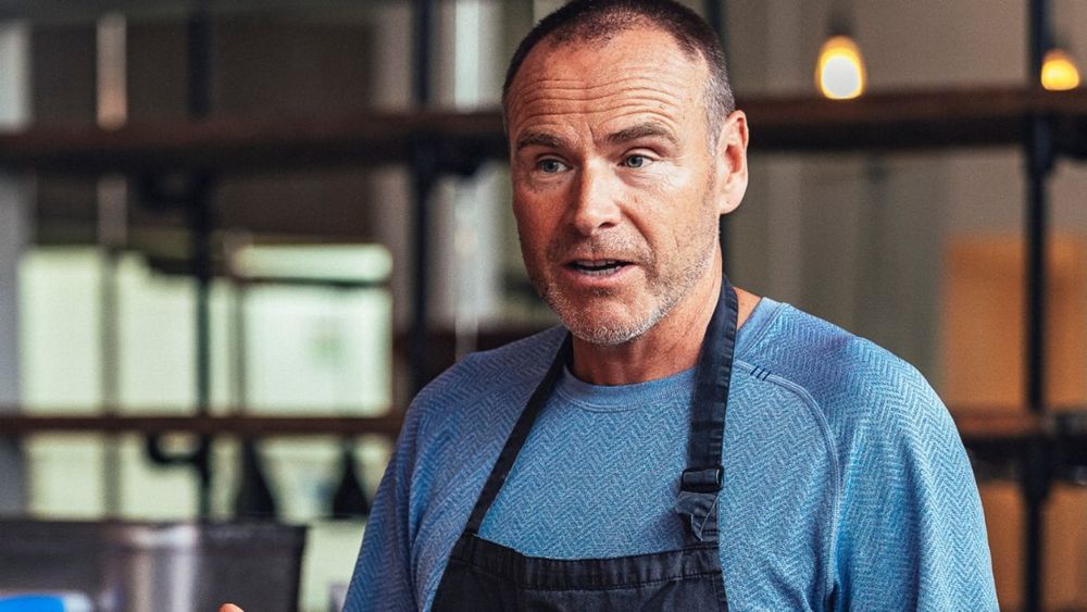 Mike Hill, co-founder of One Planet Pizza, in a blue top and apron