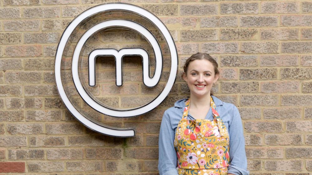 chef standing against the wall in the background with logo of Masterchef