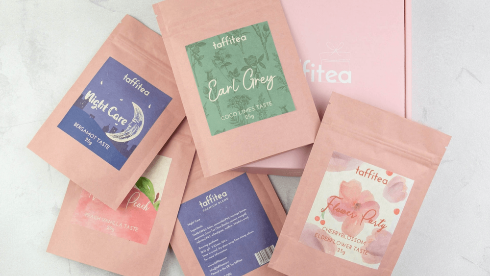 A selection of Taffitea in pink packages on a white background
