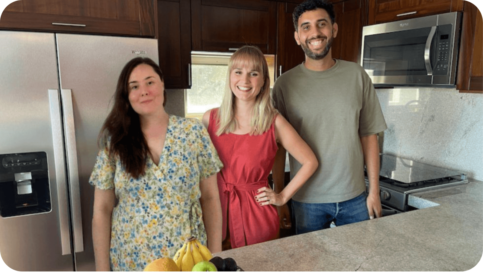 man and two women smiling in a kitchen