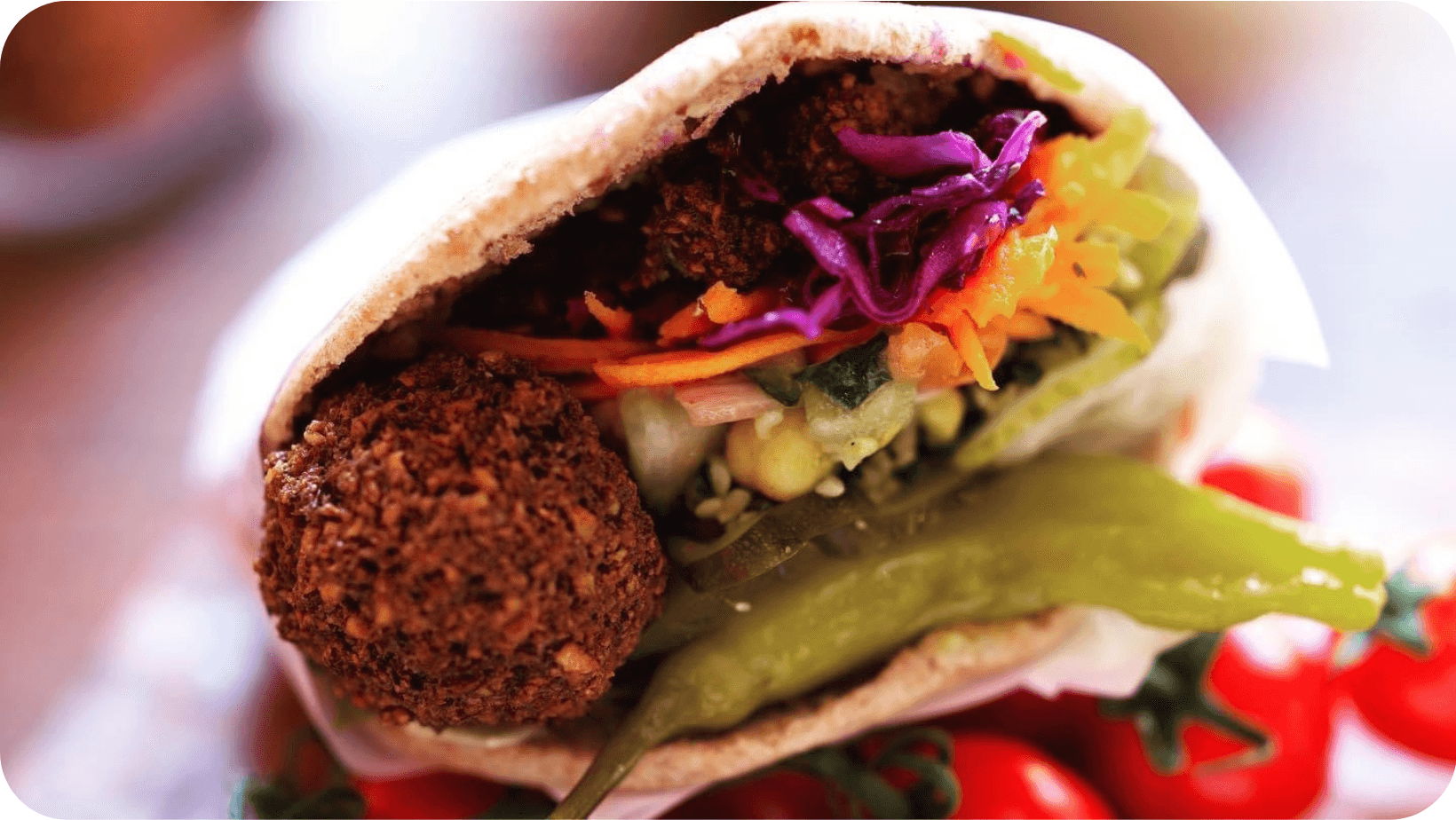 Pitta bread with falafel, pepper, cabbage  and lettuce in