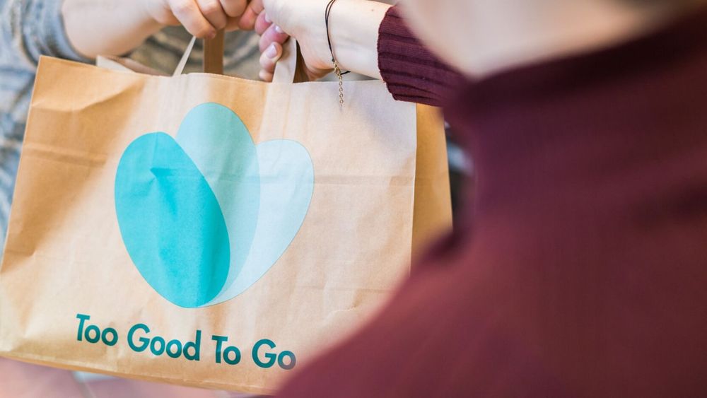 a paper bag being handed between two people