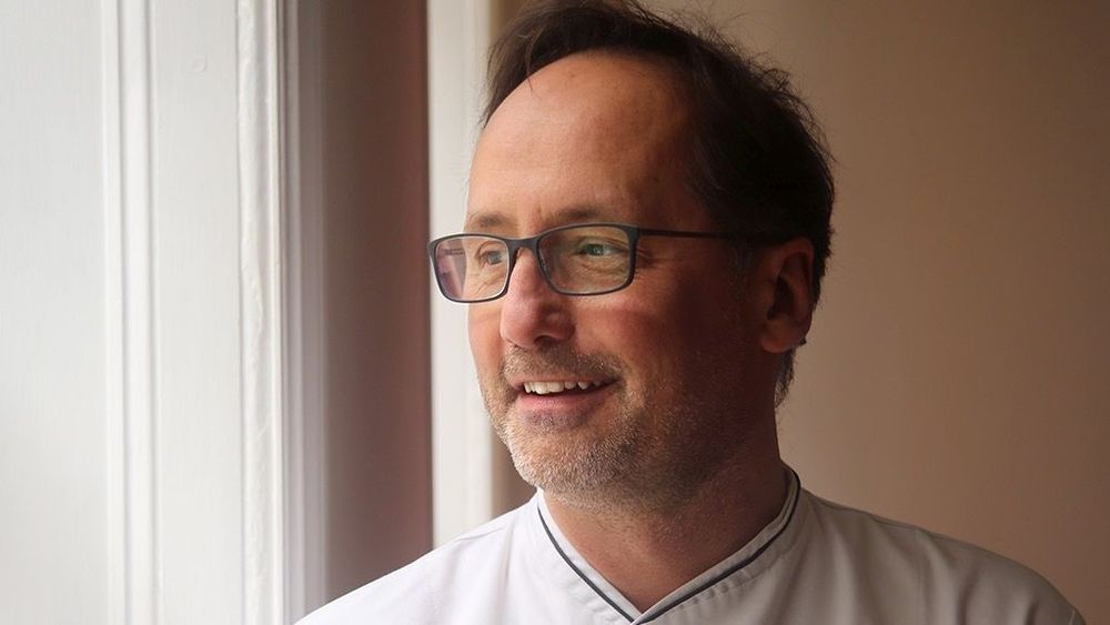 Vegan chef Alexis Gauthier smiling, he is the owner of Gauthier Soho the first vegan fine dining restaurant