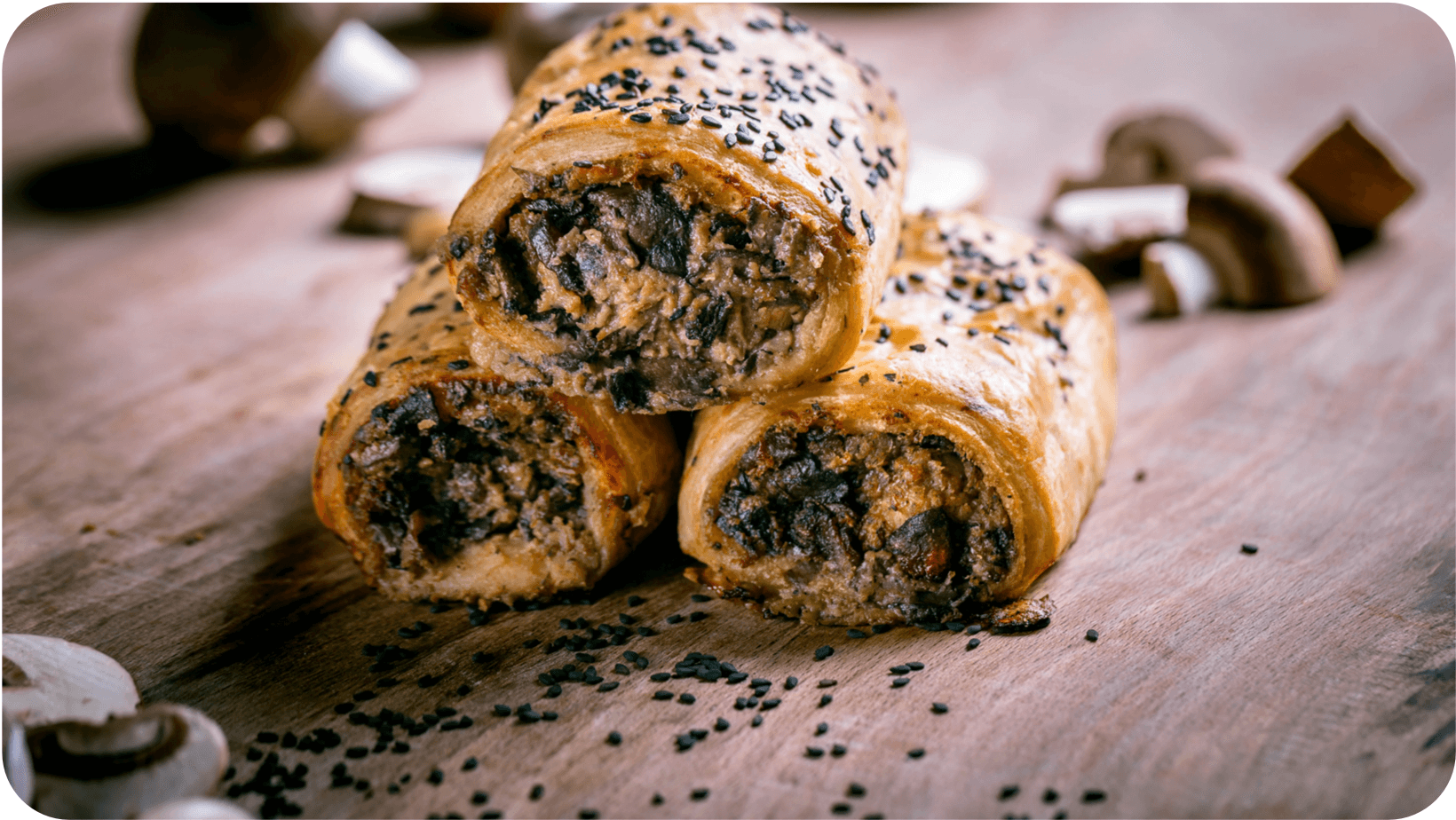 Three of Arapina Bakery’s mushroom rolls on top of each other surrounded by mushrooms