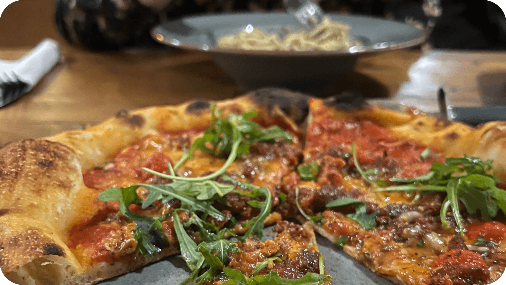 Vegano Newcastle’s vegan Nduja pizza with rocket on top in the foreground and a vegan carbonara in the background 