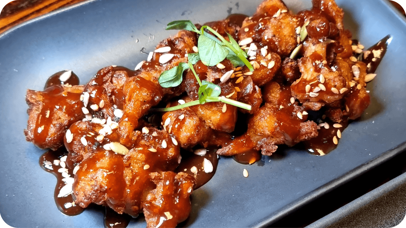 Metropole Bar Brighton’s Gochujang Cauliflower Wings served on a blue plate