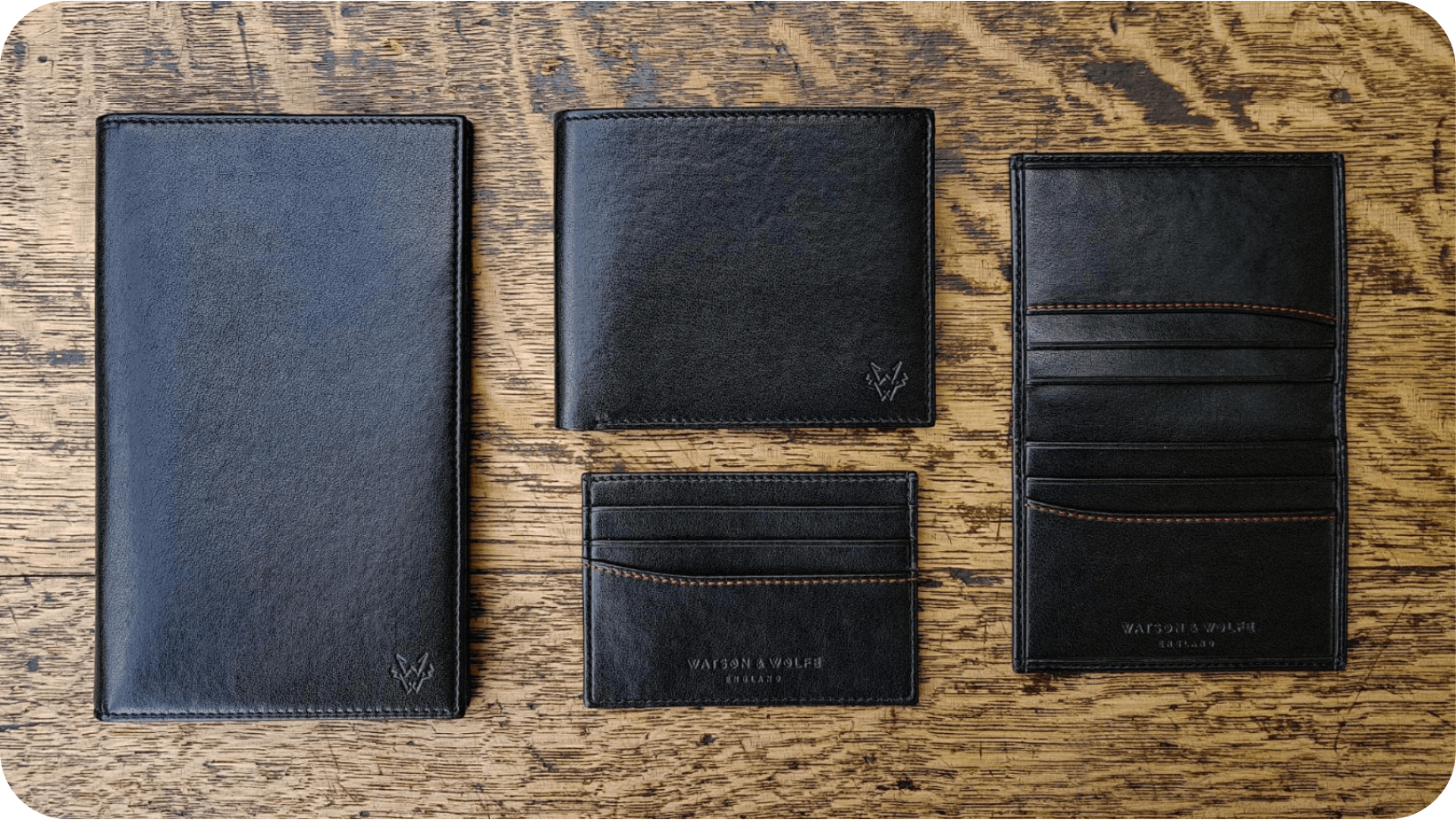 Black vegan leather wallets on a wooden table