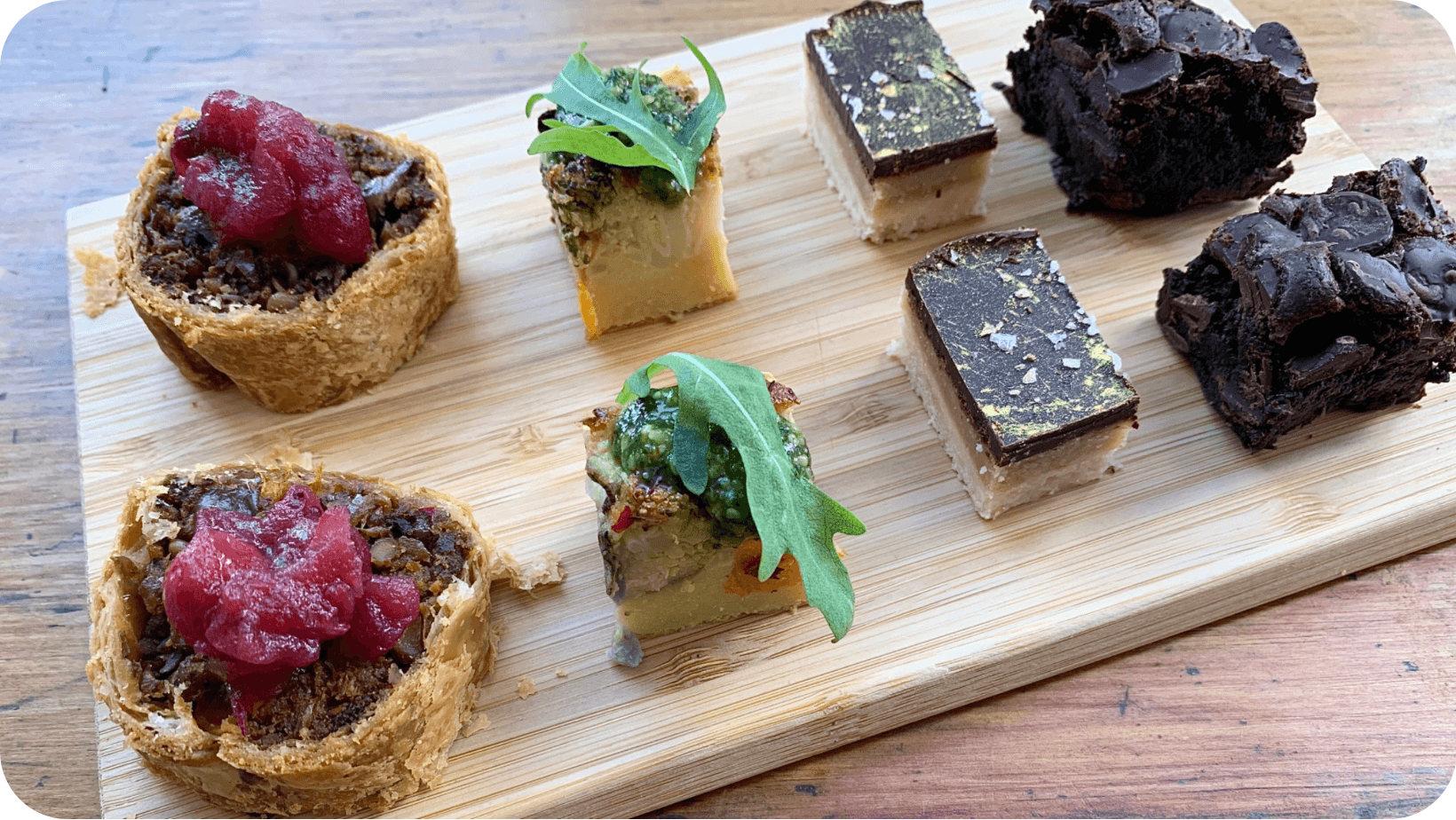 A variety of vegan snacks on a wooden board