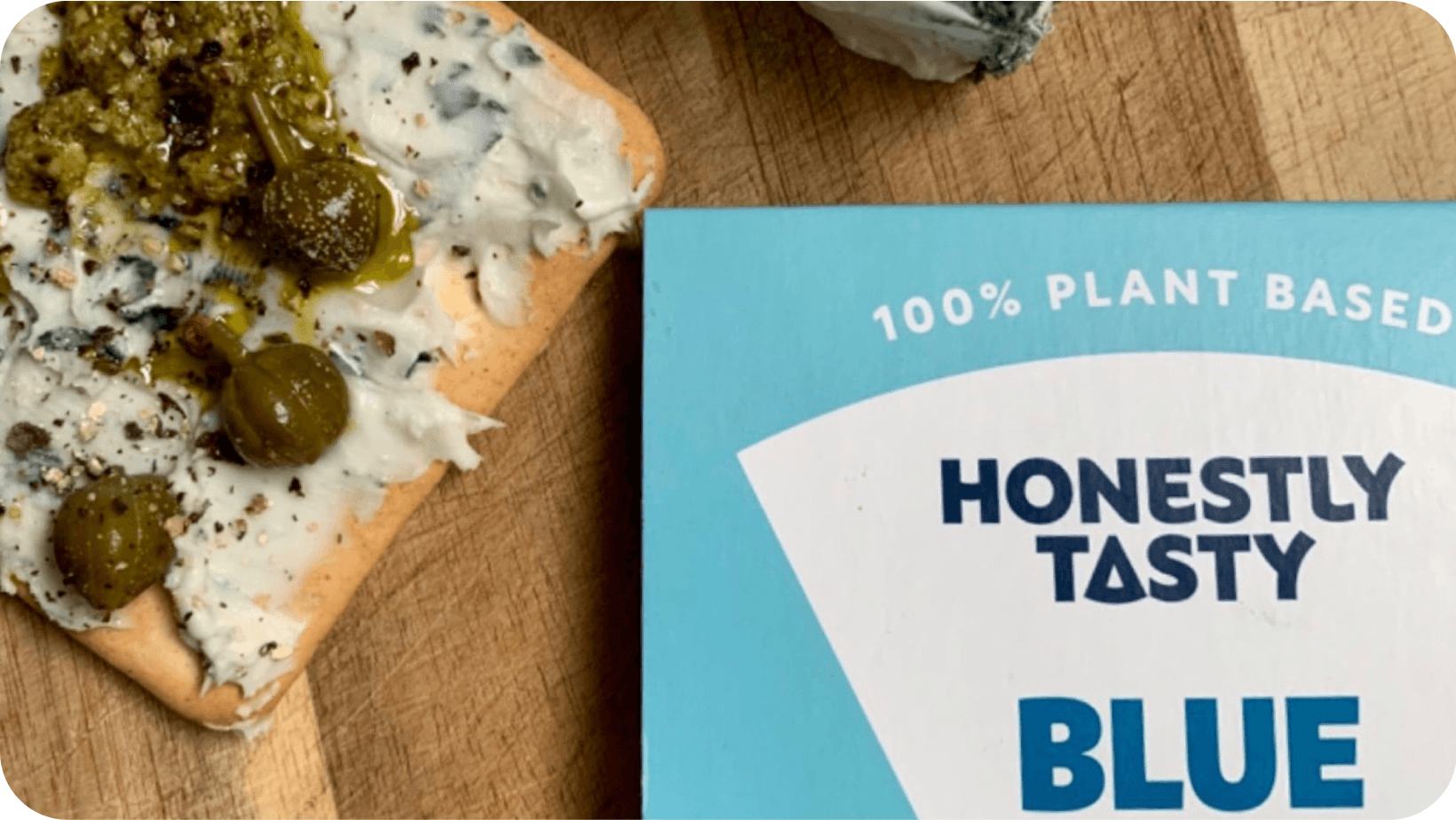 Vegan blue cheese segment next to a cracker with the cheese spread over it