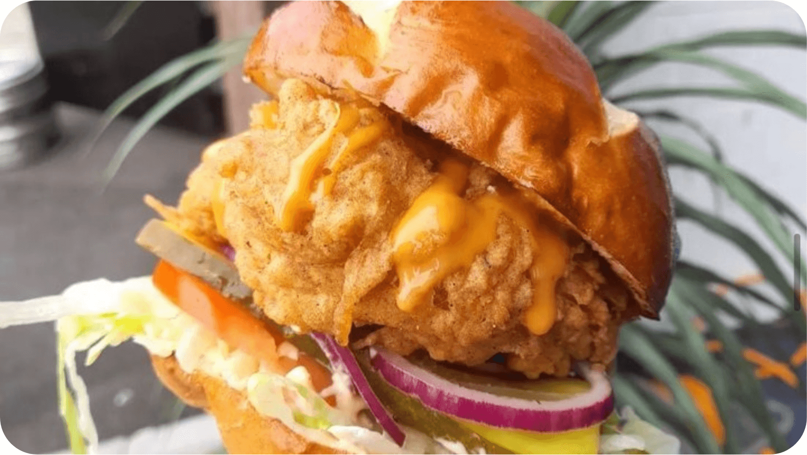 Vegan burger in a brioche bun with toppings and filings